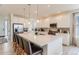 Modern kitchen with stainless steel appliances, a spacious island with seating, and plenty of cabinet space for storage at 17786 Olive St, Broomfield, CO 80023
