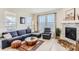 Comfortable living room with a cozy sectional, fireplace, and large windows offering a pleasant view at 17786 Olive St, Broomfield, CO 80023