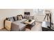 Living room with a cozy sectional couch, a wooden coffee table, and a workspace setup at 17786 Olive St, Broomfield, CO 80023