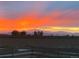 Incredible sunset view over rolling hills with a dramatic orange sky, capturing the beauty of nature at 17786 Olive St, Broomfield, CO 80023