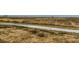 Paved walking path winding through a grassy area in a serene community at 17786 Olive St, Broomfield, CO 80023