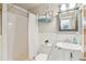 Classic bathroom with white subway tile, a pedestal sink, and a shower with a curtain at 3647 Jason St, Denver, CO 80211