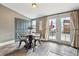 Charming dining area with a round table, slate tile flooring, and access to the backyard at 3647 Jason St, Denver, CO 80211