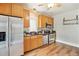 Functional kitchen with stainless steel appliances, wooden cabinets and plenty of counter space at 3647 Jason St, Denver, CO 80211