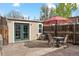 Back patio features seating, an umbrella, and outdoor access through large French doors at 3647 Jason St, Denver, CO 80211