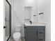 Modern bathroom featuring sleek vanity, black hardware, and glass shower doors at 16565 Black Rose Cir, Parker, CO 80134