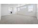 Expansive bonus room with neutral carpet, large windows, and ample space at 16565 Black Rose Cir, Parker, CO 80134