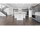 Bright kitchen with a large island, grey cabinetry, and stainless steel appliances at 16565 Black Rose Cir, Parker, CO 80134