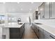 Modern kitchen featuring grey cabinets, quartz countertops and stainless steel appliances at 16565 Black Rose Cir, Parker, CO 80134