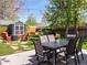 Landscaped backyard featuring a patio with dining table and seating, a firepit, and string lights at 2517 W 44Th Ave, Denver, CO 80211