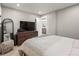 Serene bedroom features a TV, dresser, and soft bedding creating a cozy and relaxing atmosphere at 2517 W 44Th Ave, Denver, CO 80211