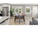 Bright dining room with a modern table and chairs, lots of natural light and stainless fridge at 2517 W 44Th Ave, Denver, CO 80211