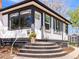 Inviting front porch with a decorative flower pot and concrete steps to the front door at 2517 W 44Th Ave, Denver, CO 80211