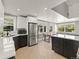 Bright kitchen with stainless steel appliances, quartz countertops and open dining area at 2517 W 44Th Ave, Denver, CO 80211