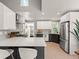 Modern kitchen featuring a quartz countertop, stainless appliances, and dark bottom cabinetry at 2517 W 44Th Ave, Denver, CO 80211