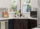 Bright kitchen featuring stainless steel sink, black faucet, and modern countertops with a sunlit window view at 2517 W 44Th Ave, Denver, CO 80211
