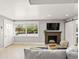 Cozy living room features a fireplace, sliding barn door, and plenty of natural light at 2517 W 44Th Ave, Denver, CO 80211