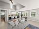 Modern living room with a vaulted ceiling, a comfortable couch, and an open view into the kitchen at 2517 W 44Th Ave, Denver, CO 80211