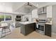 Open-concept living space with kitchen island, modern appliances, and a cozy living area at 2517 W 44Th Ave, Denver, CO 80211