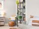 Comfortable living space featuring stylish furniture, decor, and a large shelving unit with plants and books at 2517 W 44Th Ave, Denver, CO 80211