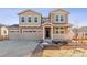 Charming two-story home with a three car garage, covered porch, and neutral tan and beige color palette at 25076 E 41St Ave, Aurora, CO 80019