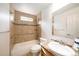 Bathroom features a soaking tub, tiled walls, grab bars, and a modern sink and vanity at 124 3Rd St, Fort Lupton, CO 80621