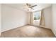 Neutral bedroom showcasing a ceiling fan, window with curtains, and plush carpeting at 124 3Rd St, Fort Lupton, CO 80621