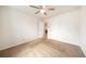 Bright bedroom with ceiling fan and two entry doors, leading to other areas of the home at 124 3Rd St, Fort Lupton, CO 80621