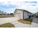 Exterior of the two-car garage, featuring a driveway and low-maintenance yard at 124 3Rd St, Fort Lupton, CO 80621