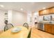 Bright dining area with a view of the kitchen featuring stainless steel appliances and hardwood floors at 124 3Rd St, Fort Lupton, CO 80621
