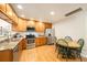 Well-equipped kitchen with stainless steel appliances, wooden cabinets, and a cozy breakfast nook at 124 3Rd St, Fort Lupton, CO 80621