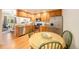 Modern kitchen features stainless steel appliances, wooden cabinets, and an adjacent dining area at 124 3Rd St, Fort Lupton, CO 80621