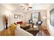 Bright living room features hardwood floors, large windows, and comfortable seating with a stylish rug at 124 3Rd St, Fort Lupton, CO 80621