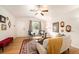 Bright living room features hardwood floors, large windows, and comfortable seating with a stylish rug at 124 3Rd St, Fort Lupton, CO 80621