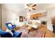 Bright living room featuring hardwood floors, large windows, and access to the kitchen and dining area at 124 3Rd St, Fort Lupton, CO 80621