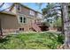 Spacious backyard with a wooden deck, patio, and green lawn, perfect for outdoor living at 9524 E Caley Cir, Englewood, CO 80111