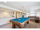 Finished basement with a pool table, wet bar, and comfortable seating area; ideal for entertaining at 9524 E Caley Cir, Englewood, CO 80111