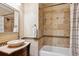 Bathroom featuring a vanity, vessel sink, and tiled shower and bath at 9524 E Caley Cir, Englewood, CO 80111