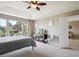 Spacious bedroom with a ceiling fan, large windows, and stylish decor at 9524 E Caley Cir, Englewood, CO 80111