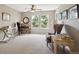 Neutral bedroom with a ceiling fan, two windows, and a desk with chair at 9524 E Caley Cir, Englewood, CO 80111
