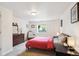Bright bedroom with a neutral color palette and ample natural light from the window at 9524 E Caley Cir, Englewood, CO 80111