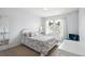 Airy bedroom featuring a patterned bedspread, bright light, and two windows at 9524 E Caley Cir, Englewood, CO 80111