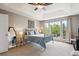 Bedroom featuring large sunny window, ceiling fan, and stylish decor at 9524 E Caley Cir, Englewood, CO 80111