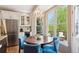 Cozy breakfast nook with a round table, blue chairs, and large windows overlooking a deck at 9524 E Caley Cir, Englewood, CO 80111