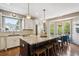 Bright kitchen with a granite island, stainless steel appliances, and a breakfast nook with large windows at 9524 E Caley Cir, Englewood, CO 80111