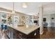 Open concept kitchen with a granite island, stainless steel appliances, and dark wood floors at 9524 E Caley Cir, Englewood, CO 80111