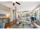 Open-concept living room with hardwood floors flowing into the kitchen, ample seating, and natural light at 9524 E Caley Cir, Englewood, CO 80111