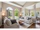 Bright living room with large arched windows, vaulted ceilings, neutral paint, and comfortable seating at 9524 E Caley Cir, Englewood, CO 80111