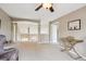 Neutral open loft area with tan carpeting, railing, and a tan console table at 9524 E Caley Cir, Englewood, CO 80111