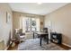 Bright home office with a large window, comfortable seating, and a wooden desk at 9524 E Caley Cir, Englewood, CO 80111